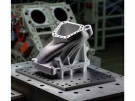 3D Systems and Oerlikon AM Partner to Advance Metal 3D Printing for Aerospace and Defense High-resolution realistic photograph of a metal 3D printed aerospace component produced by 3D Systems and Oerlikon AM, photographed in a real industrial or aerospace environment, matching the look of existing press images about the same partnership. Avoid futuristic or stylized elements.