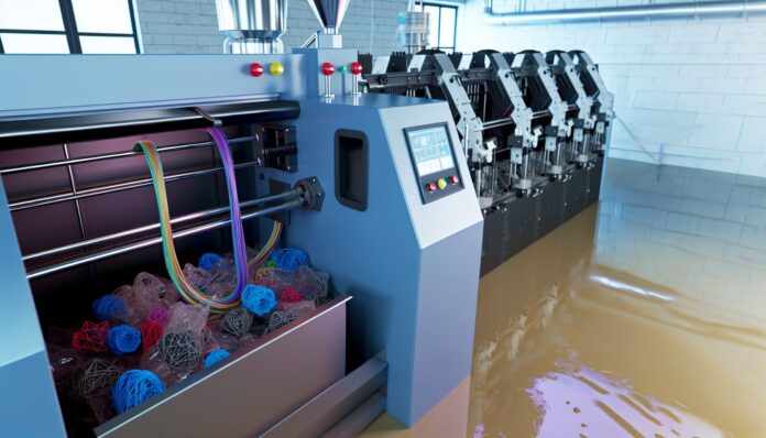 High-resolution realistic photograph of ExtrudeX recycling failed 3D prints into filament, photographed in a real workshop or makerspace environment, matching the look of existing press images about the same product. Avoid futuristic or stylized elements.