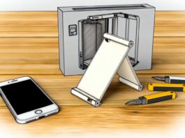 High-resolution realistic photograph of a 3D-printed foldable iPhone dummy model, placed on a wooden desk next to a real iPhone and 3D printer tools. Avoid futuristic or stylized elements.