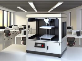 High-resolution realistic photograph of Inkbit's office-friendly metal 3D printer using metal ink, placed in a modern office or lab environment with natural lighting. Avoid futuristic or stylized elements.