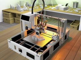High-resolution realistic photograph of a 3D printer in action, surrounded by various printed objects, photographed in a real environment, matching the look of existing press images about 3D printing. Avoid futuristic or stylized elements.