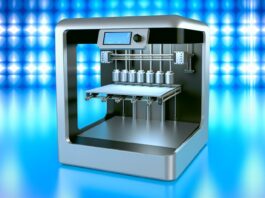 High-resolution realistic photograph of a 3D printer with 12 nozzles, photographed in a real environment, matching the look of existing press images about the same. Avoid futuristic or stylized elements.