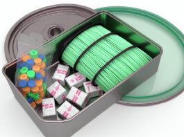 High-resolution realistic photograph of 3D printer filament stored in an airtight container with desiccant packs, photographed in a real environment, matching the look of existing press images about the same topic. Avoid futuristic or stylized elements.