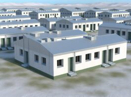 High-resolution realistic photograph of 3D-printed barracks at Fort Bliss, photographed in a real environment, matching the look of existing press images about the same. Avoid futuristic or stylized elements.