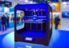 9 Obscure 3D Printing Sites You Need To Check Out High-resolution realistic photograph of a 3D printer in action, photographed in a real environment, matching the look of existing press images about the same. Avoid futuristic or stylized elements.