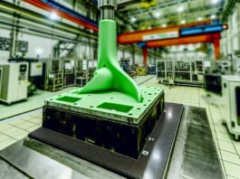 High-resolution realistic photograph of a 3D-printed wind turbine blade mold in a manufacturing setting, photographed in a real environment, matching the look of existing press images about the same. Avoid futuristic or stylized elements.